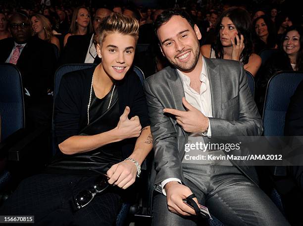 Singer Justin Bieber and manager Scoot Braun pose in the audience at the 40th American Music Awards held at Nokia Theatre L.A. Live on November 18,...