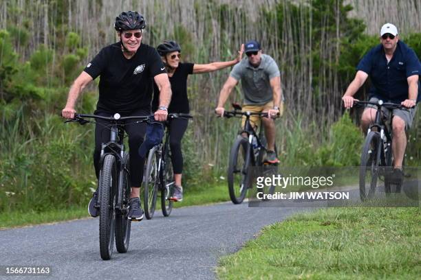 First lady Jill Biden and US President Joe Biden ride bikes through Gordons Pond State Park in Rehoboth Beach, Delaware on July 31, 2023.