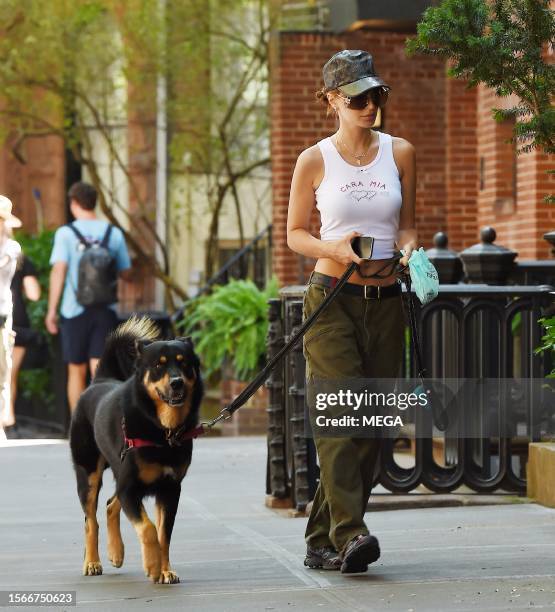 Emily Ratajkowski is seen taking her dog for a walk on July 31, 2023 in New York, New York.