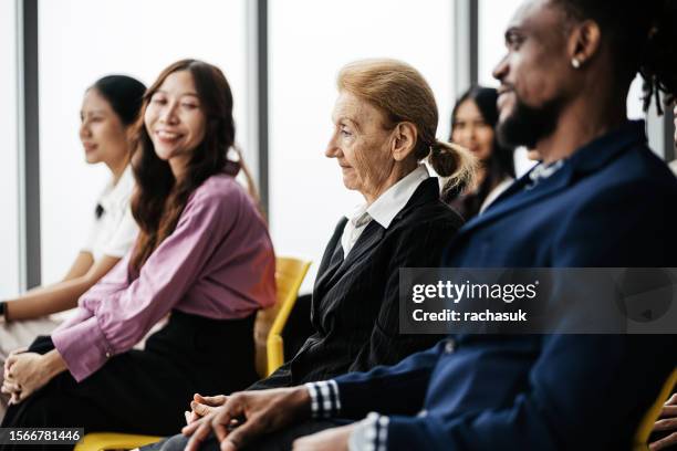 a beautiful woman in agreement while listening to her coworker - succession planning stock pictures, royalty-free photos & images