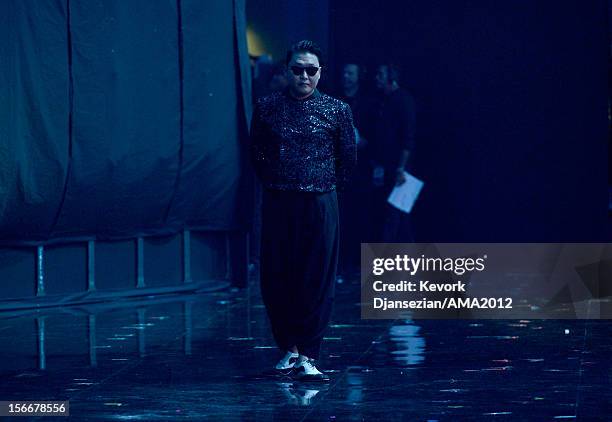 Psy walks backstage at the 40th American Music Awards held at Nokia Theatre L.A. Live on November 18, 2012 in Los Angeles, California.