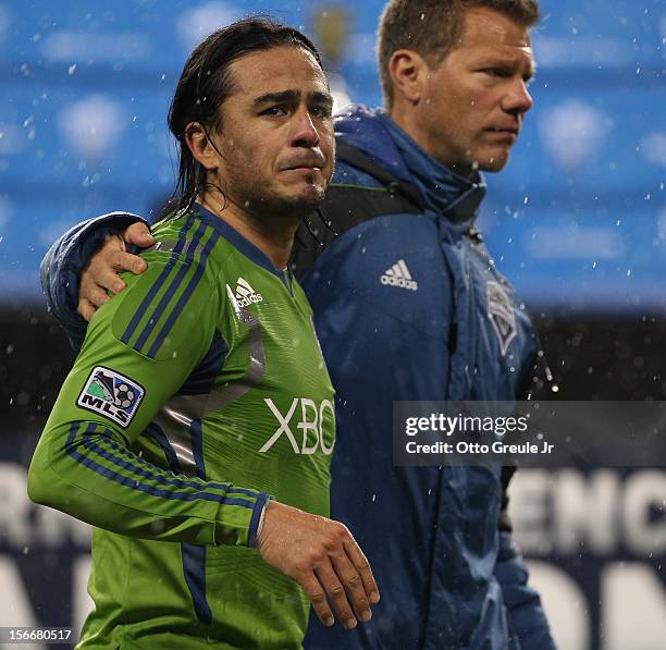 Mauro Rosales and assistant coach David Tenney of the Seattle Sounders FC walk off the pitch after the match against the Los Angeles Galaxy during...