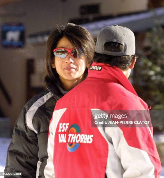 Chinese singer Gao Qi is seen with his sky instructor, 20 November 2004 in Val Thorens in the French Alps prior surfing. The Chinese star is to...