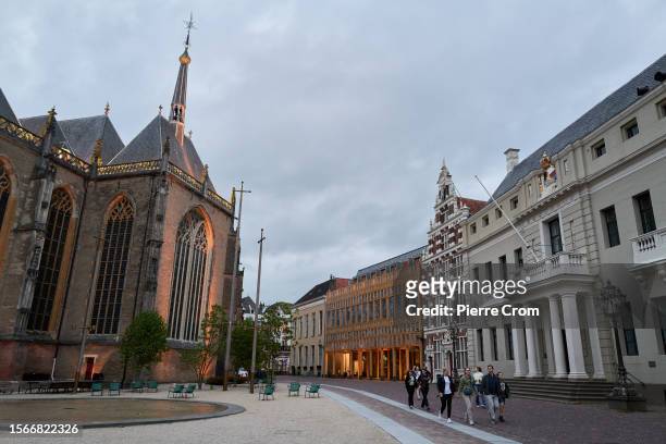 People walk past the Sint Lebuinus Church and the city hall on July 30, 2023 in Deventer, Netherlands. Although the tiny Dutch nation exports a vast...