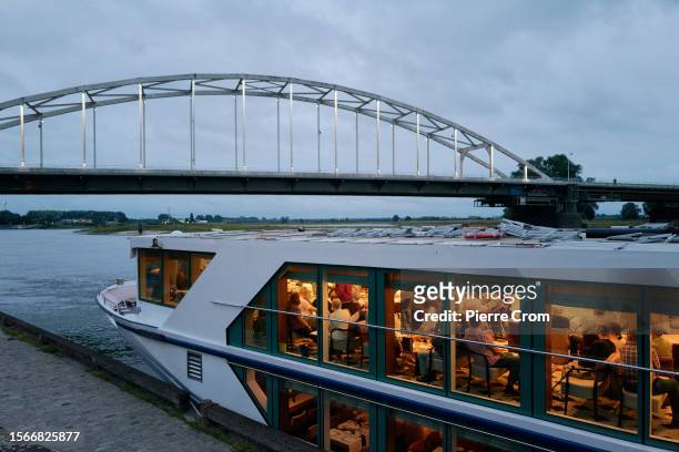 German tourists enjoy a show on a cruise ship on the Ijssel river on July 30, 2023 in Deventer, Netherlands. Although the tiny Dutch nation exports a...