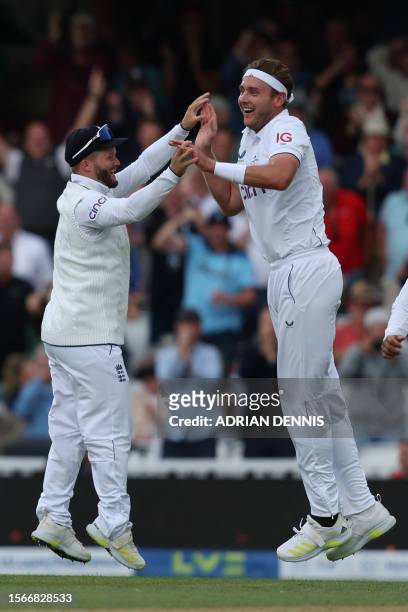 England's Stuart Broad celebrates with England's Ben Duckett after taking the wicket of Australia's Todd Murphy on day five of the fifth Ashes...