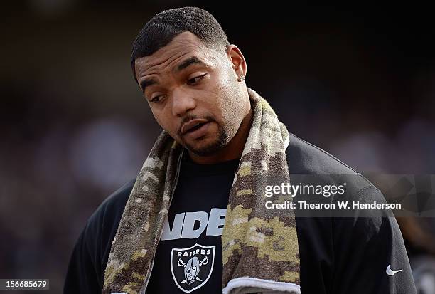 Richard Seymour Oakland Raiders not in uniform against the New Orleans Saints looks on from the sidelines during an NFL football game at O.co...