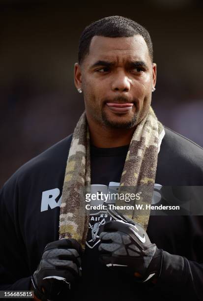 Richard Seymour Oakland Raiders not in uniform against the New Orleans Saints looks on from the sidelines during an NFL football game at O.co...