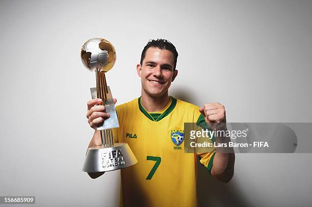 Vinicius of Brazil poses with the trophy in the locker room after winning the FIFA Futsal World Cup Final at Indoor Stadium Huamark on November 18,...