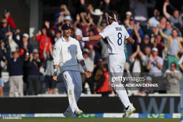 England's Stuart Broad celebrates with England's James Anderson after taking the final wicket, that of Australia's wicket keeper Alex Carey resulting...