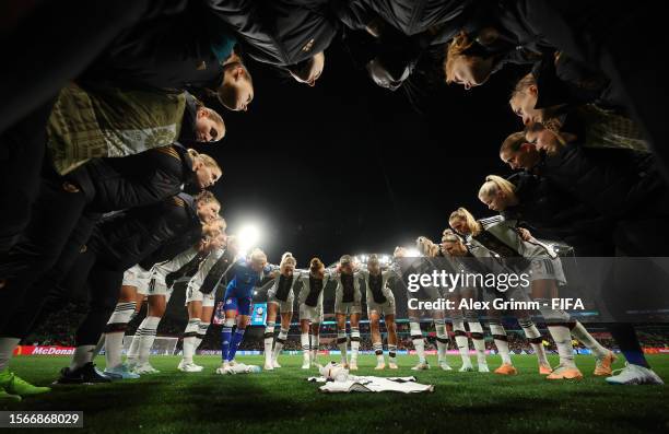 Germany players huddle around the shirt of injured and withdrawn Carolin Simon prior to the FIFA Women's World Cup Australia & New Zealand 2023 Group...