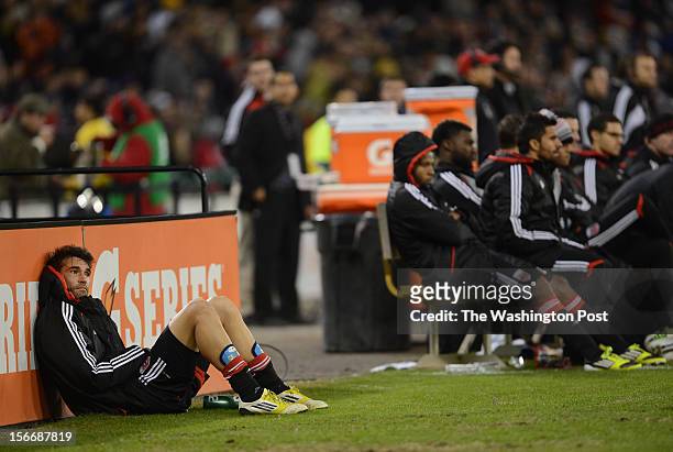 United defender Emiliano Dudar , left, watches the final minutes from the sidelines after being taken out of the second game of the Eastern...