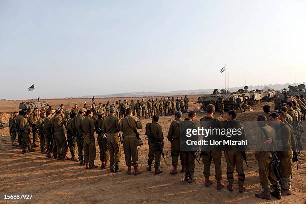 Israeli soldiers gather for morning prayers in a deployment area on November 19, 2012 on Israel's border with the Gaza Strip. The death toll has...
