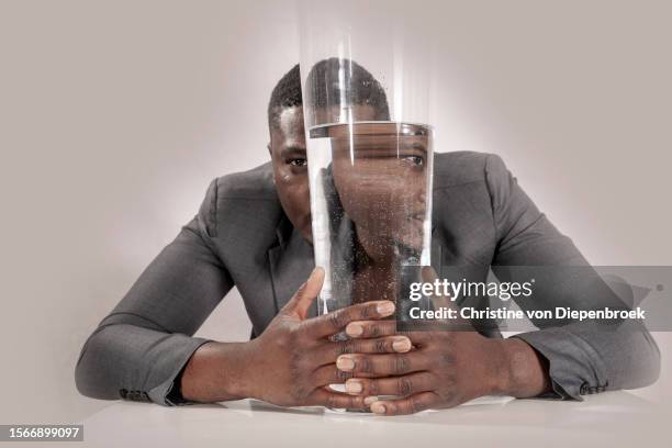 young african man at table - distorted image stock pictures, royalty-free photos & images