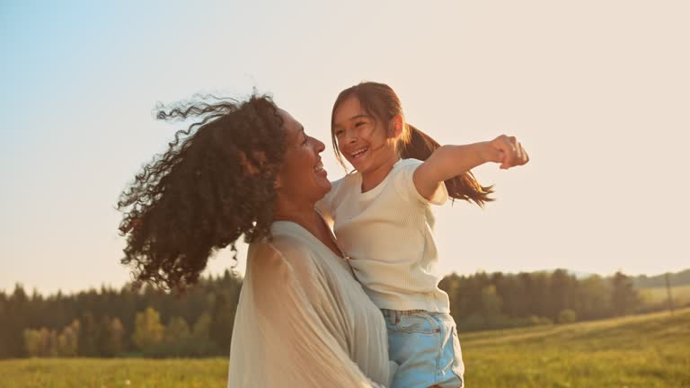 https://media.gettyimages.com/id/1566907571/video/mother-holding-her-daughter-as-they-spin-in-the-meadow-at-sunset.jpg?b=1&s=640x640&k=20&c=9Ip8ksgbU8KZsKdilrlQAXxRHAOJmZON8_A-fIQECWw=