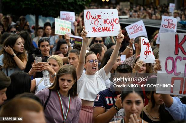 Woman holds a placard reading "How many more women?" and shouts slogans during a demonstration against domestic violence in Sofia, on July 31, 2023....