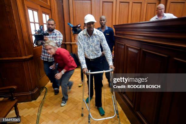 Xolile Mngeni, the man accused of killing Swedish honeymooner Anni Dewani, walks with a Zimer frame as he arrives into the Cape Town's High Court on...