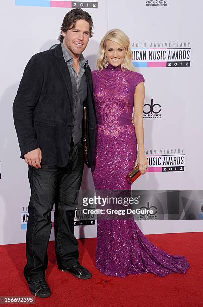 Singer Carrie Underwood and husband Mike Fisher arrive at the 40th Anniversary American Music Awards at Nokia Theatre L.A. Live on November 18, 2012...