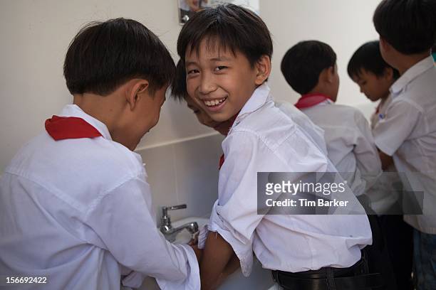 Children from Le Thanh Van Primary School wash their hands in their new bathroom during a media briefing for World Toilet Day on November 19, 2012 in...