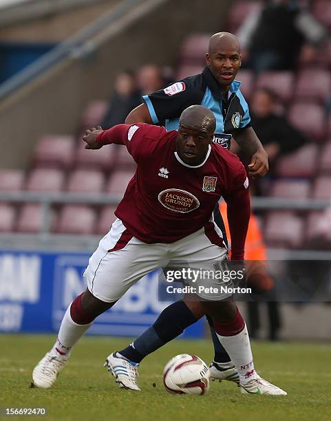 Adebayo Akinfenwa of Northampton Town attempts to control the ball under pressure from Leon Johnson of Wycombe Wanderers during the npower League Two...