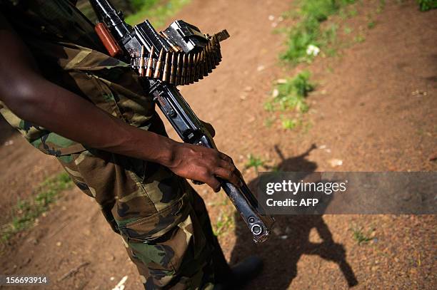 An M23 rebel stands holding a machine gun at a forward position in the hills of Kanyarucinya on the outskirts of Goma, in the east of the Democratic...