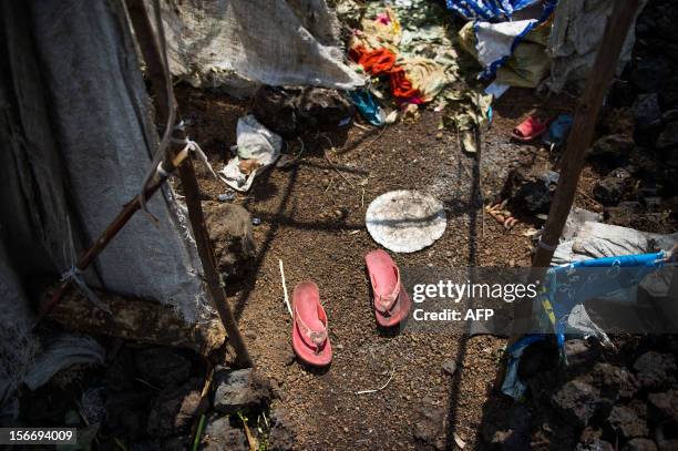 Pair of abandoned sandals stand in the entrance to a stripped shelter built in Kanyarucinya on the outskirts of Goma in the restive North Kivu...