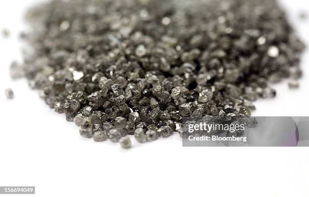 Group of uncut diamonds, identified for use in industrial processes are seen on a sorting table at the De Beers office in London, U.K., on Friday,...