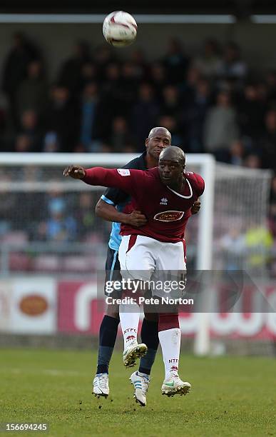 Adebayo Akinfenwa of Northampton Town challenges for the ball with Leon Johnson of Wycombe Wanderers during the npower League Two match between...