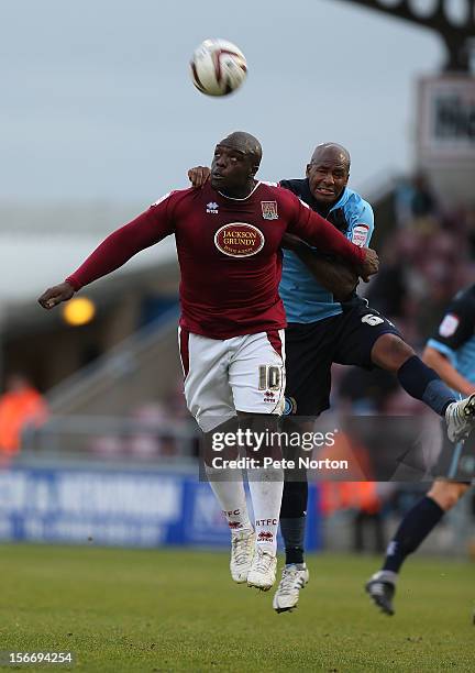 Adebayo Akinfenwa of Northampton Town challenges for the ball with Leon Johnson of Wycombe Wanderers during the npower League Two match between...