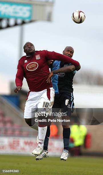 Adebayo Akinfenwa of Northampton Town challenges for the ball with Leon Johnson of Wycombe Wanderers during the npower League Two match between...