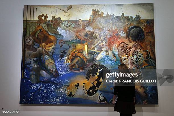Visitor looks at a painting entitled "Peche au thon" by Spanish surrealist artist Salvador Dali during an exhibition devoted to his work at the...