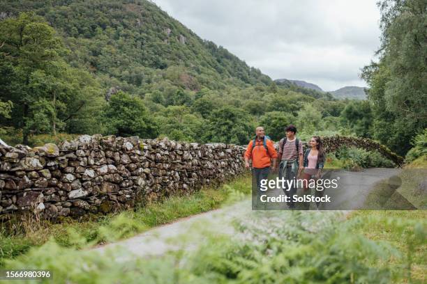 scenic lake district trail - family wide angle stock pictures, royalty-free photos & images