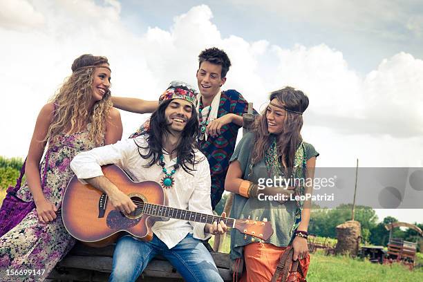 hippie group play guitar together - hippie stockfoto's en -beelden