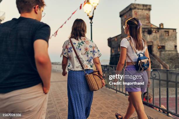 family sightseeing town of rapallo, liguria on a warm summer evening - street promenade stock pictures, royalty-free photos & images