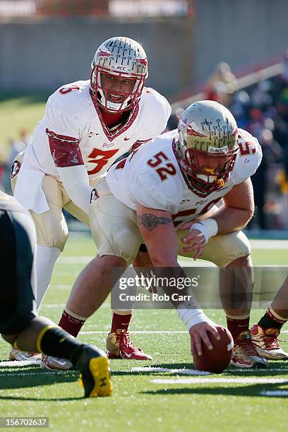 Quarterback EJ Manuel prepares to take a snap from center Bryan Stork of the Florida State Seminoles during the first half against the Maryland...