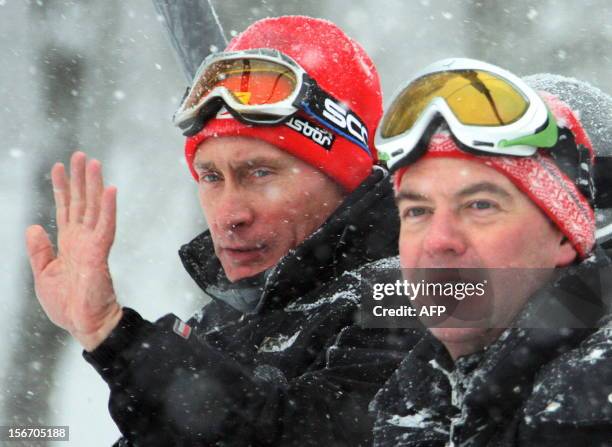 President Dmitry Medvedev and Prime Minister Vladimir Putin sit on a chair lift at Krasnaya Polyana resort outside Sochi on January 4, 2009. AFP...