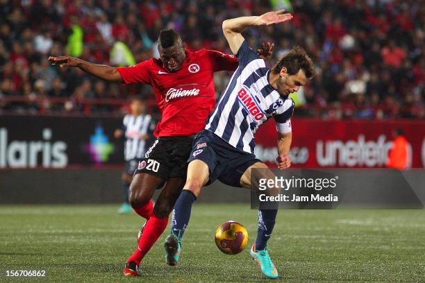 Duvier Riascos of Tijuana struggles for the ball with Jose Maria Basanta of Monterrey during a match between Tijuana and Monterrey as part of the...
