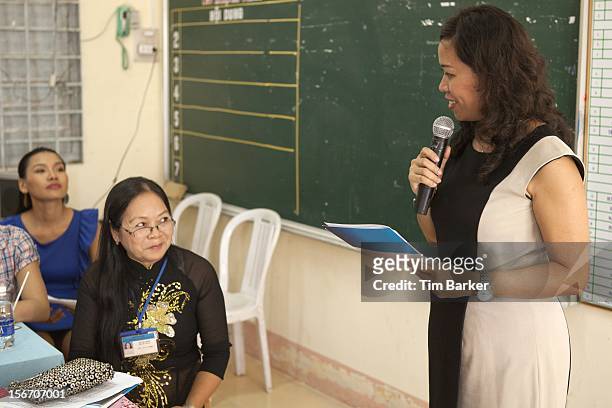 Marketing Vice President of Unilever Vietnam Nguyen Thi Bich Van speaks as Principal of Le Thanh Van Primary School Ha Thi Dung looks on during the...
