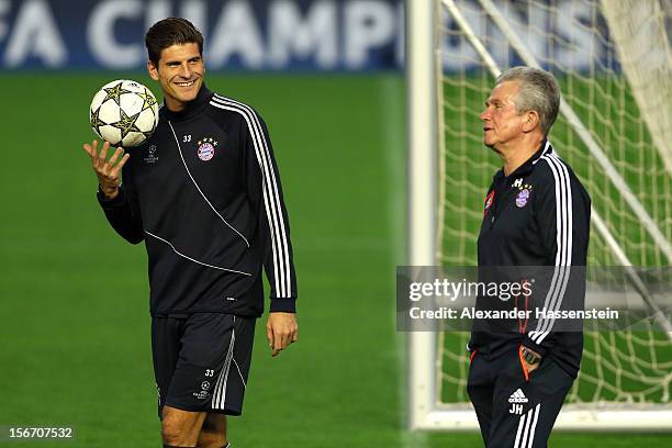 Jupp Heynckes , head coach of Muenchen talks to his player Mario Gomez during a FC Bayern Muenchen training session ahead of their UEFA Champions...
