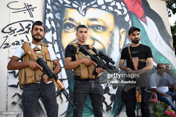 Men with weapons are seen during the funeral ceremony of Abu Sheref el-Armoushi, Fatah Movement member and 3 guards who were killed in clashes...