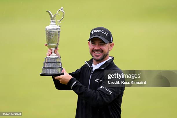 Brian Harman of the United States poses for a photograph with the Claret Jug on the 18th green as he celebrates winning The 151st Open on Day Four of...