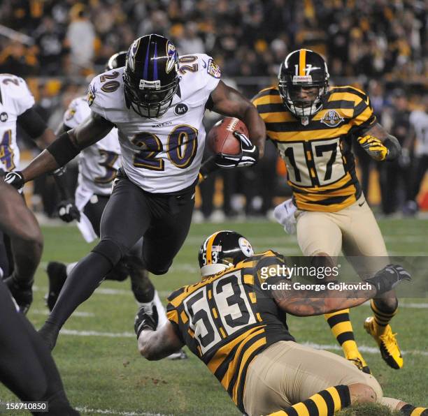 Safety Ed Reed of the Baltimore Ravens leaps to avoid a tackle by Maurkice Pouncey of the Pittsburgh Steelers as he runs with the football after...