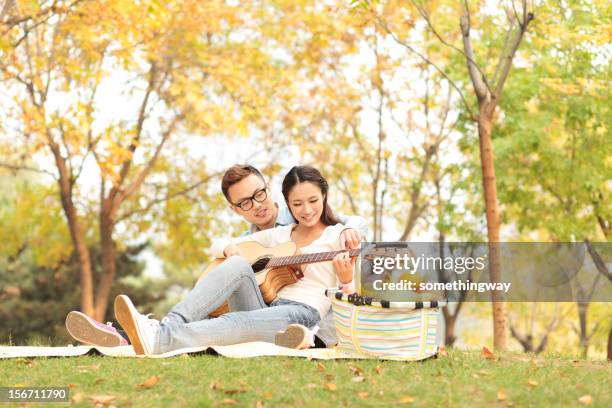 beautiful smiling couple - university student picnic stock pictures, royalty-free photos & images