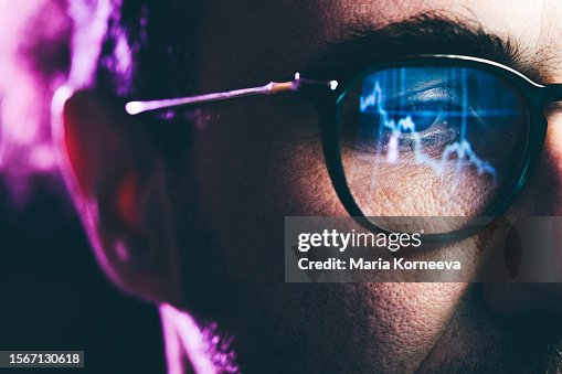Close-up Portrait of man Working on Computer. Сhart Reflecting in Glasses. Data Analytics Statistics Information Business Technology. Close-up Portrait of man Working on Computer. Сhart Reflecting in Glasses. Data Analytics Statistics Information Business Technology.