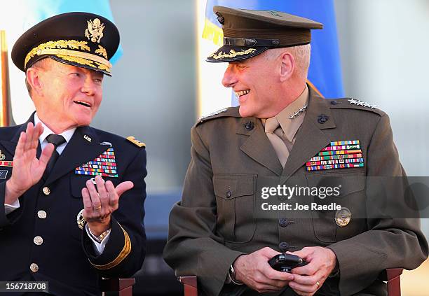 Marine General John F. Kelly shares a laugh with U.S Army General Martin E. Dempsey, Chairman, Joint Chiefs of Staff, after he was handed his new...