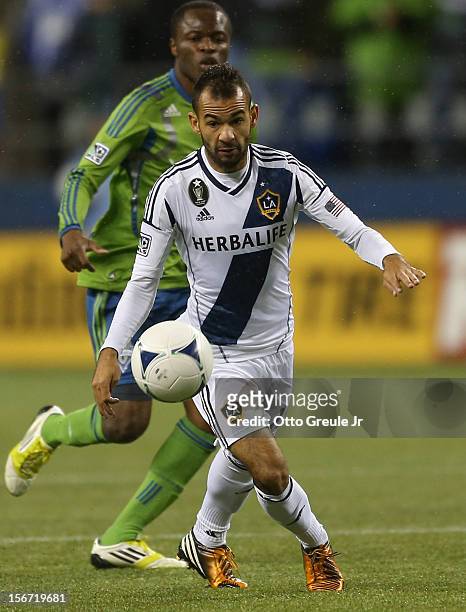 Juninho of the Los Angeles Galaxy dribbles against Steve Zakuani of the Seattle Sounders FC during Leg 2 of the Western Conference Championship at...