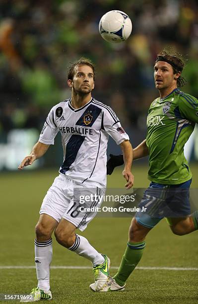 Mike Magee of the Los Angeles Galaxy battles Jeff Parke of the Seattle Sounders FC during Leg 2 of the Western Conference Championship at CenturyLink...