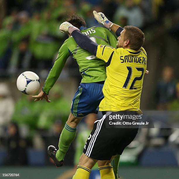 Goalkeeper Josh Saunders of the Los Angeles Galaxy battles Brad Evans of the Seattle Sounders FC during Leg 2 of the Western Conference Championship...