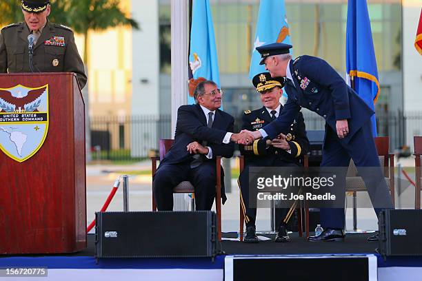 Secretary of Defense Leon Panetta shakes hands with U.S. Air Force General Douglas Fraser as U.S. Army General Martin Dempsey, Chairman, Joint Chiefs...