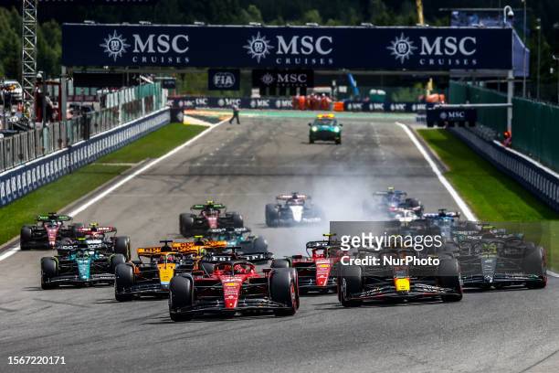 Charles Leclerc of Ferrari, Sergio Perez of Red Bull Racing and rest of the drivers are seen during the start of the F1 Grand Prix of Belgium at...